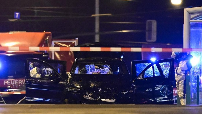 Forensics police inspect the car that rammed into a crowd at a Christmas market in Magdeburg, eastern Germany, on December 21, 2024. German police arrested a Saudi Arabian man after a deadly car-ramming attack on a Christmas market December 20, 2024 in which an SUV barrelled through a crowd of revellers at high speed, leaving a trail of bloody carnage. At least two people were killed, one of them a young child, and 68 injured, said authorities in the city of Magdeburg, located about 130 kilometres (80 miles) southwest of Berlin. Families were crowded at the market set up around a large Christmas tree in the centre of Magdeburg when a BMW barrelled towards them around 7 pm (1800 GMT). (Photo by John MACDOUGALL / AFP)