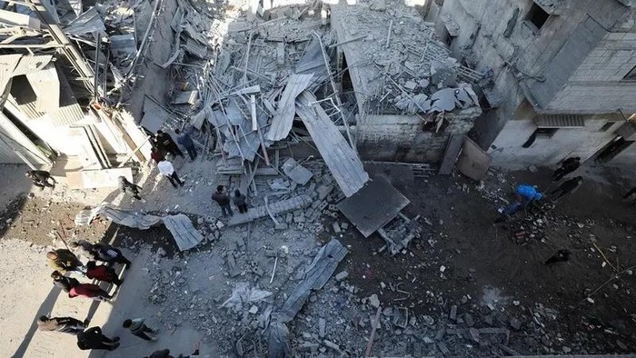 Palestinians inspect the site of an Israeli airstrike on a house, amid the ongoing conflict between Israel and Hamas, in Gaza City, on December 19, 2024. (Reuters)