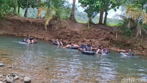 Wisatawan menggunakan pelampung ban untuk menyusuri aliran sungai