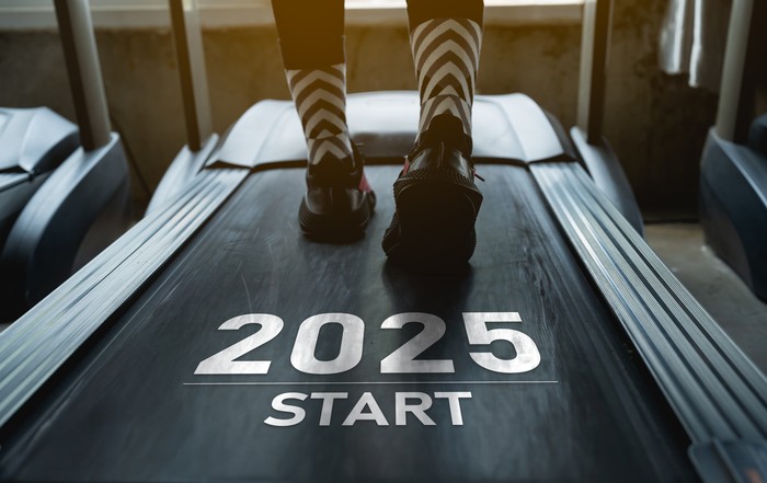 Happy new year 2025,2025 symbolizes the start of the new year. Close up of feet, sportswoman runner running on treadmill in fitness club. Cardio workout. Healthy lifestyle, guy training in gym.