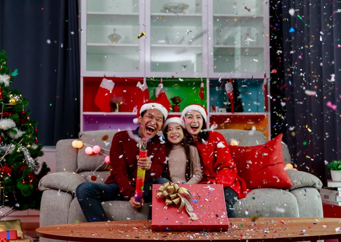 Merry Christmas, Asian young family celebrate Christmas and new year party, Christmas playing confetti poppers