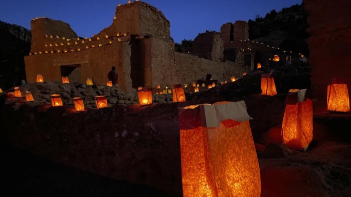 Traditional luminarias, also known as farolitos, flicker throughout the Jemez Historic Site during the annual Lights of Gisewa event in Jemez Springs, New Mexico, on Friday, Dec. 13, 2024. (AP Photo/Susan Montoya Bryan)