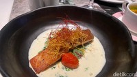 Pilihan main course pada set menu dinner Special December ini sangat nikmat. Satu di antaranya ada Confit Atlantic Trout yang sajiannya berupa salmon panggang dengan paduan saus creamy dari campuran tangerine butter dan dilengkapi potage parmentier dan garlic kale. Foto: detikFood/Yenny Mustika Sari