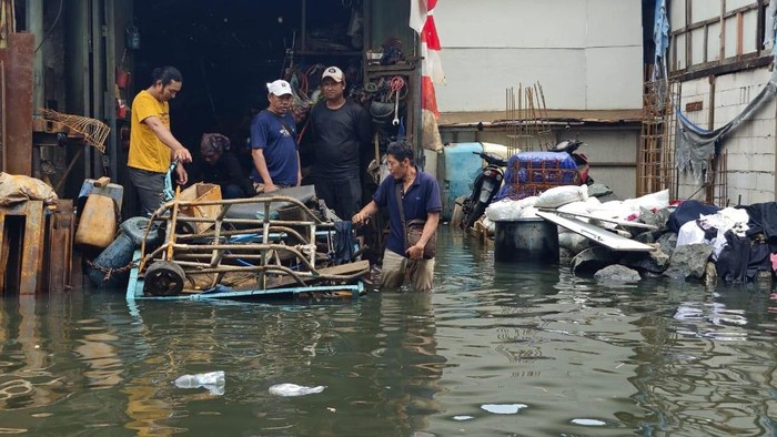 Situasi banjir rob saat masih semata kaki di Muara Karang sebelum akhirnya naik hingga sepinggul orang dewasa, Selasa (17/12/2024). (Fajar Yusuf Rasdianto/detikX)