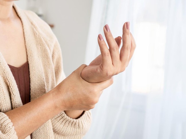 woman suffering from wrist pain, numbness, or Carpal tunnel syndrome hand holding her ache joint