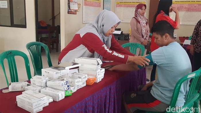 Warga mengalami keluagan muntah dan demam saat mendatangi posko Kesehatan di Balai Desa Tluwah Kecamatan Juwana, Kabupaten Pati, Rabu (25/12/2024).