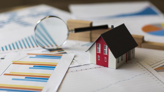 Miniature House on A Financial Graph