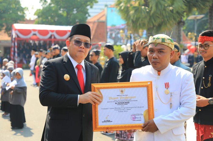 M. Fathur Rozi saat mendapat penghargaan dari Pj Gubernur Jatim Adhy Karyono
