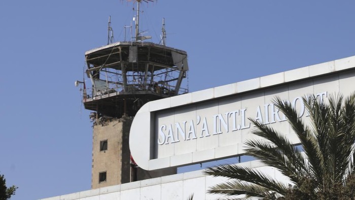 Workers walk past broken glass in Sana'a International Airport following Thursday's Israeli airstrikes on Yemen, Friday, Dec. 27, 2024. The Israeli military reported targeting infrastructure used by the Houthis at the Sanaa International Airport, as well as ports in Hodeida, Al-Salif, and Ras Qantib, along with power stations Thursday Dec. 26..(AP Photo/Osamah Abdulrahman)