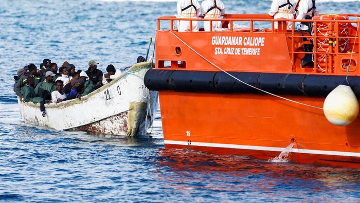 A Spanish Coast Guard vessel tows a fibreglass boat with migrants onboard to the port of Arguineguin, on the island of Gran Canaria, Spain, December 25, 2024. REUTERS/Borja Suarez