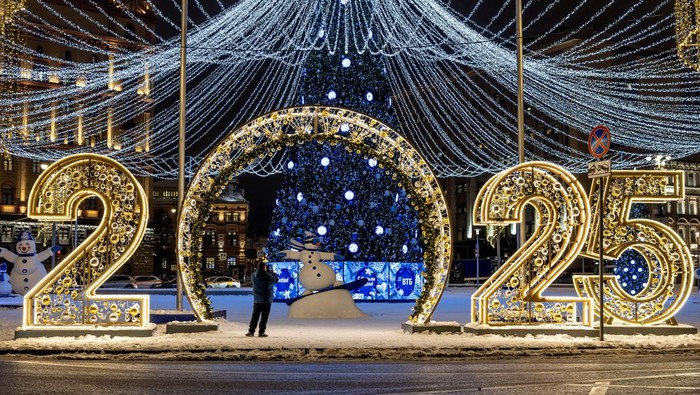 A man takes photos of New Year and Christmas season decorations in Moscow, Russia, December 11, 2024. REUTERS/Maxim Shemetov