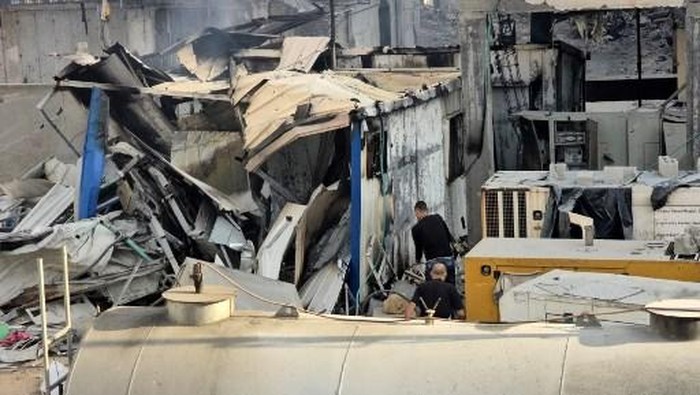 People check the damage outside the Kamal Adwan hospital in Beit Lahia in the northern Gaza Strip, following Israeli strikes around the medical complex on December 6, 2024, as the war between Israel and the Palestinian Hamas militant group continues. (Photo by AFP)