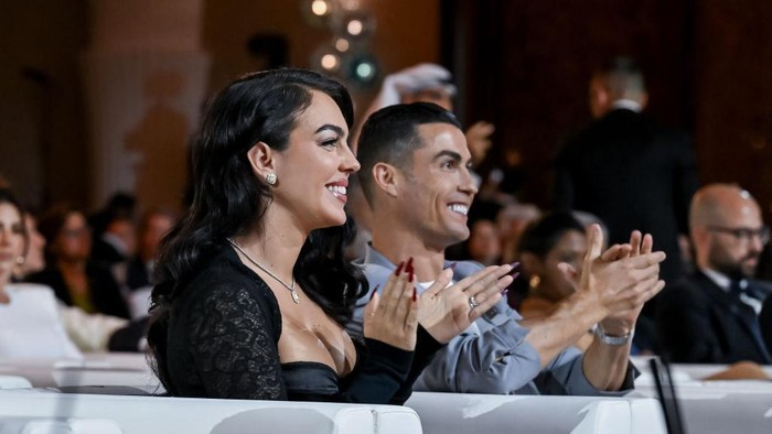 DUBAI, UNITED ARAB EMIRATES - DECEMBER 27: Al-Nassr player Cristiano Ronaldo (2nd L) and Georgina Rodriguez (L) attend the Globe Soccer Dubai Awards 2024 as part of the Dubai International Sports Conference 2024 in Dubai, United Arab Emirates (UAE) on December 27, 2024. (Photo by Waleed Zein/Anadolu via Getty Images)