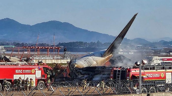 Firefighters carry out extinguishing operations on an aircraft which drove off runaway at Muan International Airport in Muan, South Jeolla Province, South Korea, December 29, 2024. Yonhap via REUTERS THIS IMAGE HAS BEEN SUPPLIED BY A THIRD PARTY. NO RESALES. NO ARCHIVES. SOUTH KOREA OUT. NO COMMERCIAL OR EDITORIAL SALES IN SOUTH KOREA.