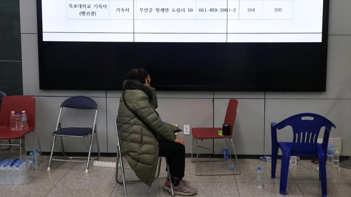 A relative of a passenger of the aircraft that crashed after it went off the runway reacts at Muan International Airport, in Muan, South Korea, December 30, 2024. REUTERS/Kim Hong-Ji
