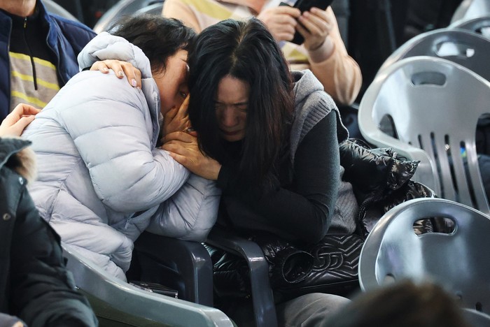 A relative of a passenger of the aircraft that crashed after it went off the runway reacts at Muan International Airport, in Muan, South Korea, December 30, 2024. REUTERS/Kim Hong-Ji
