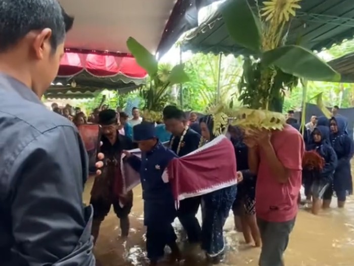 Pengantin di Ponorogo ini menggelar resepsi pernikahan di tengah banjir. Postingan tersebut langsung mendapatkan banjir komentar dari warganet.