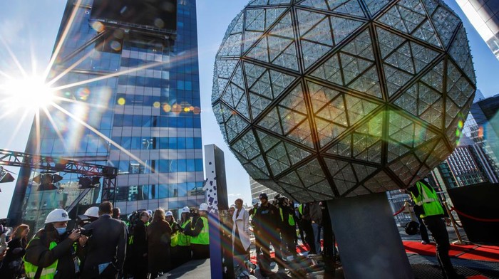 Organizers of the upcoming ball drop on New Year's Eve are reflected off a building window as they do a drop test in Times Square, New York, U.S., December 30, 2024. REUTERS/Eduardo Munoz