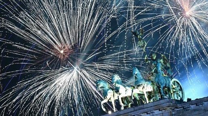 Fireworks illuminate the Quadriga atop the Brandenburg Gate during the New Year celebrations in Berlin on January 1, 2025. (Photo by Tobias SCHWARZ / AFP)