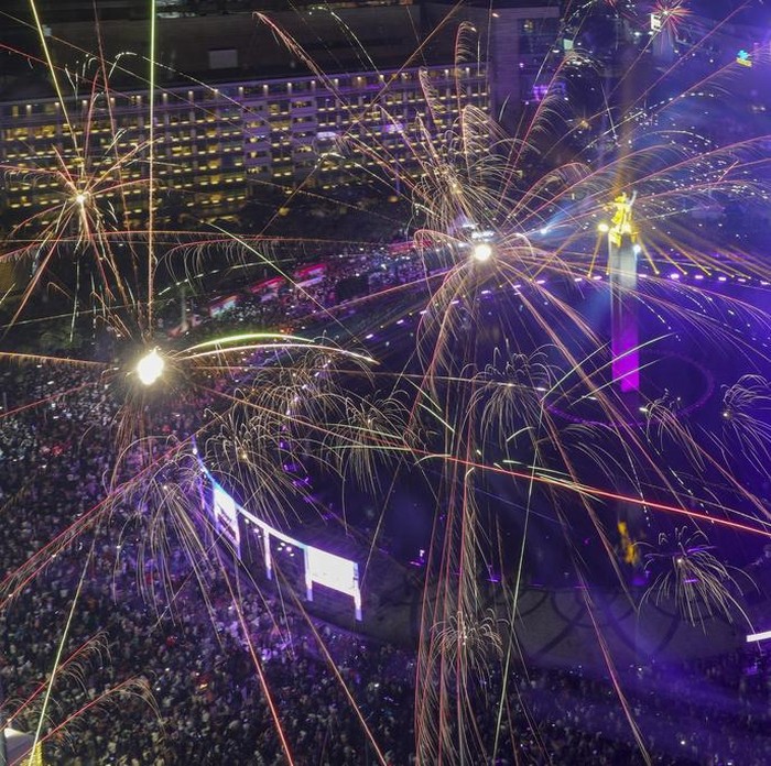 Fireworks explode as thousands of people gather in the main business district on New Years Eve in Jakarta, Indonesia, Tuesday, Dec. 31, 2024. (AP Photo/Tatan Syuflana)