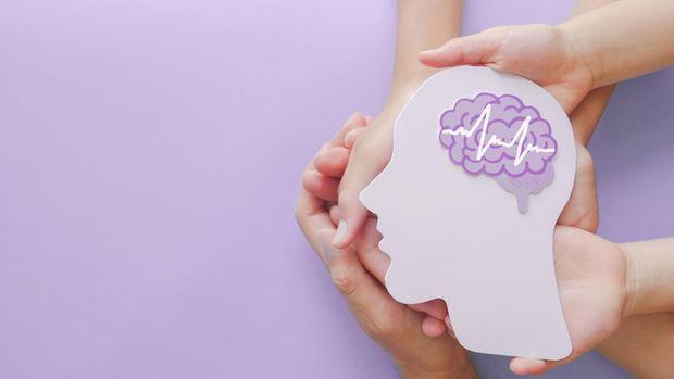 Adult and child hands holding encephalography brain paper cutout,autism, Stroke, Epilepsy and alzheimer awareness, seizure disorder, stroke, ADHD, world mental health day concept