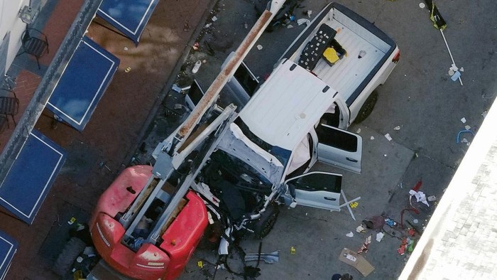Ngeri, Truk Sengaja Tabrak Kerumunan Pesta Tahun Baru di New Orleans AS A black flag with white lettering lies on the ground rolled up behind a pickup truck that a man drove into a crowd on Bourbon Street in New Orleans, killing and injuring a number of people, early Wednesday morning, Jan. 1, 2025. The FBI said they recovered an Islamic State group flag, which is black with white lettering, from the vehicle. (AP Photo/Gerald Herbert)