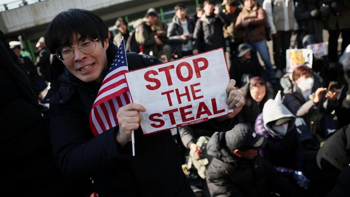 Pendukung Presiden Yoon Suk Yeol Berkumpul, Tolak Penjemputan Paksa Police officers drag away a pro-Yoon protester outside of impeached South Korean President Yoon Suk Yeol's official residence, as Yoon faces potential arrest after a court on Tuesday approved a warrant for his arrest, in Seoul, South Korea, January 2, 2025. REUTERS/Kim Hong-Ji