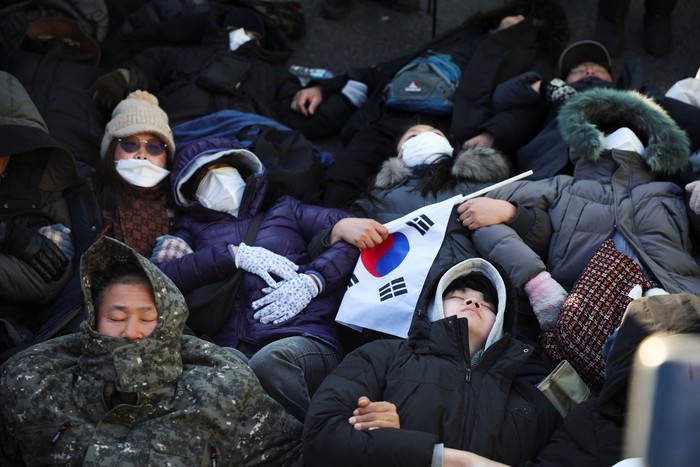 Police officers drag away a pro-Yoon protester outside of impeached South Korean President Yoon Suk Yeols official residence, as Yoon faces potential arrest after a court on Tuesday approved a warrant for his arrest, in Seoul, South Korea, January 2, 2025. REUTERS/Kim Hong-Ji