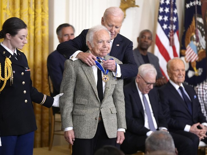 President Joe Biden, right, presents the Presidential Medal of Freedom, the Nations highest civilian honor, to fashion designer Ralph Lauren in the East Room of the White House, Saturday, Jan. 4, 2025, in Washington. (AP Photo/Manuel Balce Ceneta)