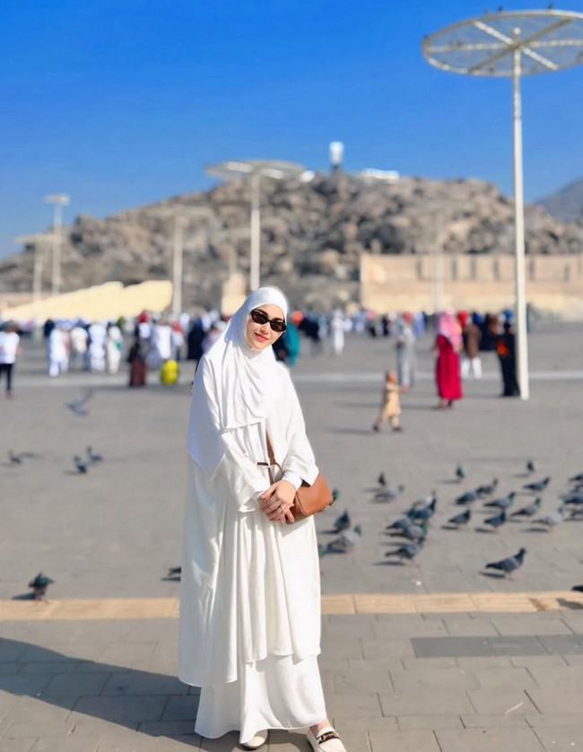Pergantian tahun baru, penyanyi Ayu Ting Ting memilih umrah bersama putrinya Bilqis Khumairah Razak dan keluarga lainnya. Ketika di Tanah Suci, Ayu Tingting tampil cantik memakai hijab dan dress serba putih. Foto: Dok. Instagram @ayutingting92.