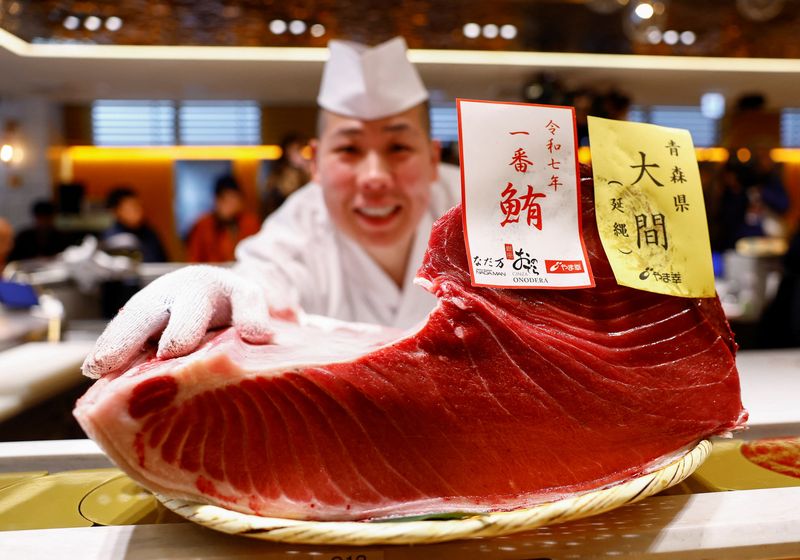 A 276-kilogram bluefin tuna that was auctioned for 207 million Japanese yen (about 1.3 million U.S. dollars), which was bought jointly by sushi restaurant operator Onodera Group and wholesaler Yamayuki, is carried into an Onodera sushi restaurant after the first tuna auction of the New Year in Tokyo, Japan January 5, 2025. REUTERS/Issei Kato