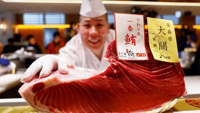 A 276-kilogram bluefin tuna that was auctioned for 207 million Japanese yen (about 1.3 million U.S. dollars), which was bought jointly by sushi restaurant operator Onodera Group and wholesaler Yamayuki, is carried into an Onodera sushi restaurant after the first tuna auction of the New Year in Tokyo, Japan January 5, 2025.  REUTERS/Issei Kato