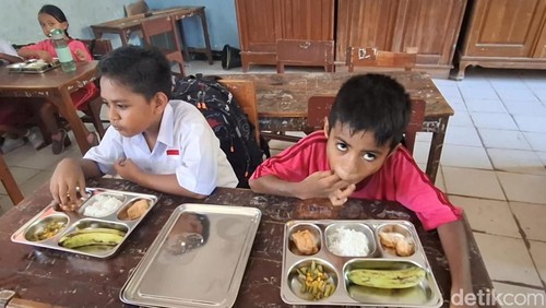 Siswa di SD GMIT Manumuti, Kecamatan Kupang Tengah, Kabupaten Kupang, NTT, saat menikmati makanan bergizi gratis, Senin (6/1/2025). (Yufengki Bria/detikBali)