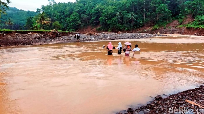 Sejumlah warga hingga pelajar kembali berjibaku melawan arus sungai