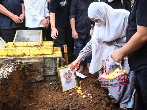 Istri pelawak sekaligus politikus Nurul Qomar, Siti Maryam (tengah) membawa bingkai foto dan berdoa saat pemakaman di TPU Carang Pulang, Pagedangan, Kabupaten Tangerang, Banten, Kamis (9/1/2025). Nurul Qomar meninggal dunia usai menjalani perawatan di RSUD Kabupaten Tangerang pada Rabu (8/1/2025). ANTARA FOTO/Sulthony Hasanuddin/foc.