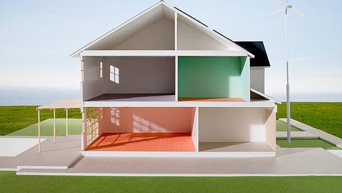 Architectural model with solar panels and windmill power generator.