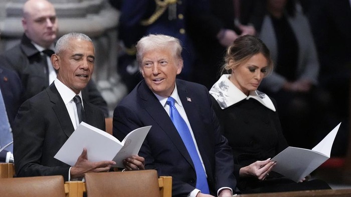 Former President Barack Obama talks with President-elect Donald Trump, next to Melania Trump, as they arrive to attend the state funeral for former President Jimmy Carter at Washington National Cathedral in Washington, Thursday, Jan. 9, 2025. (AP Pho
