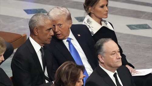 Former President Barack Obama talks with President-elect Donald Trump as Melania Trump reads the funeral program before the state funeral for former President Jimmy Carter at Washington National Cathedral in Washington, Thursday, Jan. 9, 2025. (AP Photo/Jacquelyn Martin)