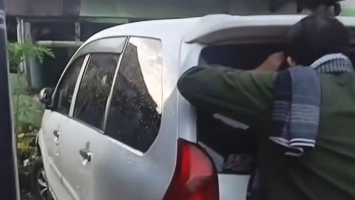 Warga saat mengecek ke dalam mobil yang ditinggal pemilik di gang sempit, di Kota Medan. (dok.Istimewa)