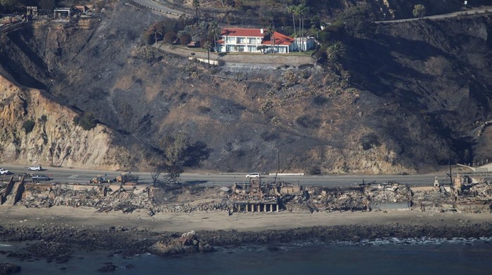 An aerial view shows debris from burned properties, as powerful winds fueling devastating wildfires in the Los Angeles area force people to evacuate, in Malibu, California, U.S. January 10, 2025. REUTERS/Daniel Cole