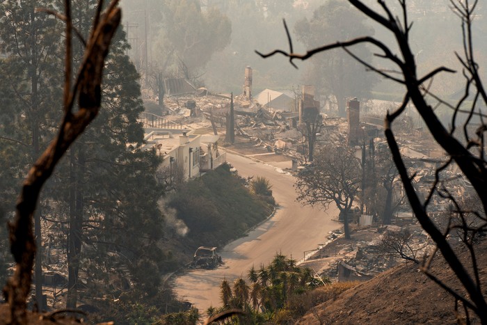 A burnt car stands amidst remains of homes following the Palisades Fire in the Pacific Palisades neighborhood in Los Angeles, California, U.S. January 10, 2025. REUTERS/David Ryder
