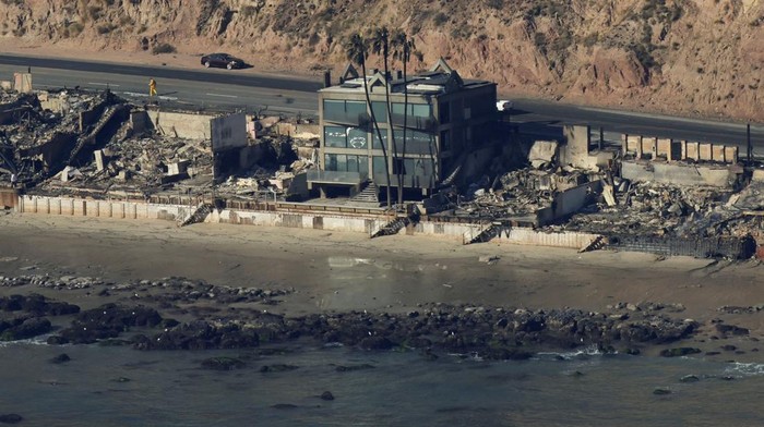 An aerial view shows debris from burned properties, as powerful winds fueling devastating wildfires in the Los Angeles area force people to evacuate, in Malibu, California, U.S. January 10, 2025. REUTERS/Daniel Cole