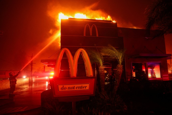 Firefighters work to extinguish flames as the Eaton Fire burns in Pasadena, California, U.S. January 7, 2025. REUTERS/Mario Anzuoni      TPX IMAGES OF THE DAY                SEARCH CALIFORNIA WILDFIRES FOR THIS STORY. SEARCH WIDER IMAGE FOR ALL STORIES.