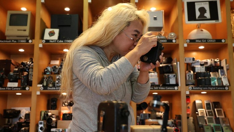 Visitors view items inside Extinct Media Museum, a private museum showcasing a collection of defunct gadgets including old cameras, cassette tapes and cell phone, in Tokyo, Japan January 11, 2025.  REUTERS/Irene Wang
