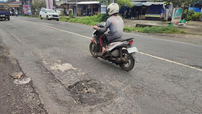Jalan rusak dan berlubang di Jalan Denpasar-Gilimanuk, Kecamatan Kerambitan, Tabanan, Bali. (Firizqi Irwan/detikBali)