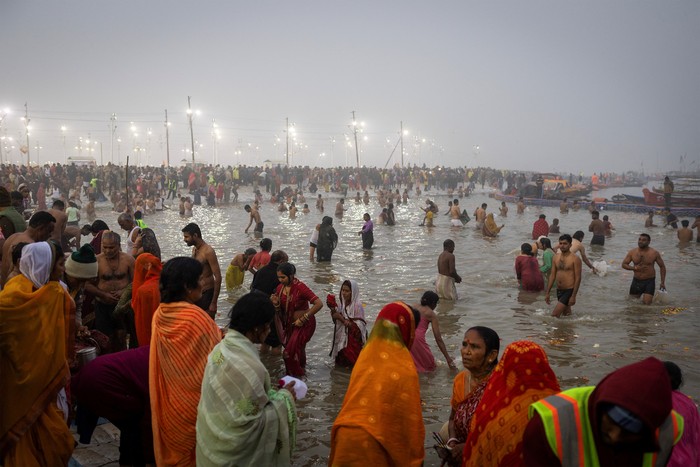 Devotees take a holy dip at Sangam, the confluence of the Ganges and Yamuna rivers with the mythical, invisible Saraswati river, during the 
