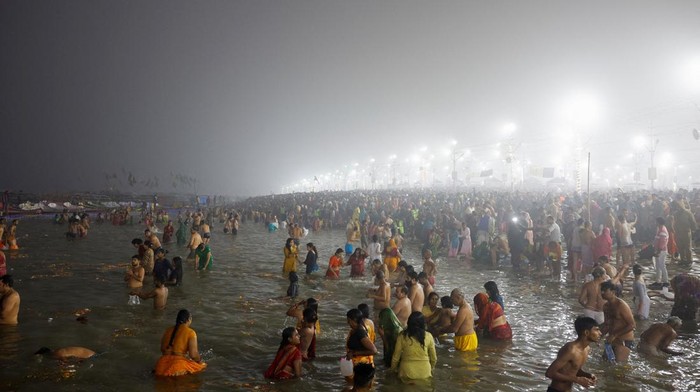 Devotees take a holy dip at Sangam, the confluence of the Ganges and Yamuna rivers with the mythical, invisible Saraswati river, during the 