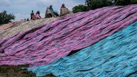 Begini saat pekerja menjemur kain pantai yang baru diwarnai.