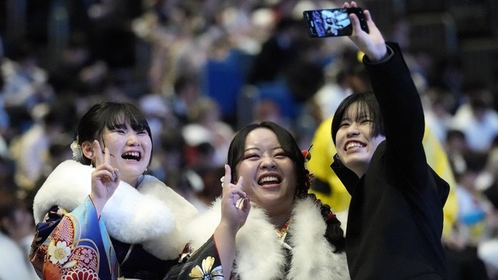 Kimono-clad women celebrate the Coming-of-Age Day, a centuries-old tradition and national holiday celebrating the milestone from child to adult, in Yokohama near Tokyo, Monday, Jan. 13, 2025. (AP Photo/Eugene Hoshiko)