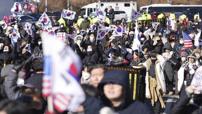 A supporter of impeached South Korean President Yoon Suk Yeol reacts during a rally to oppose his impeachment near the presidential residence in Seoul, South Korea, Wednesday, Jan. 15, 2025. (AP Photo/Lee Jin-man)